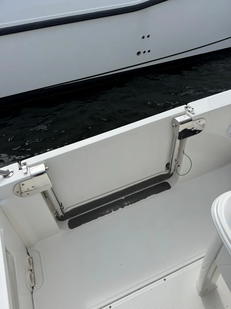 Slide: The Image of 2017 Boston Whaler 270 Dauntless boat interior, featuring a clean, white deck and railing. - 5