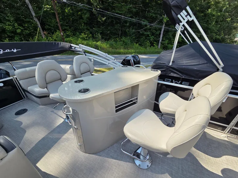 Slide: The Image of Luxurious 2018 South Bay 523 pontoon boat interior with plush seating and sleek bar area. - 10