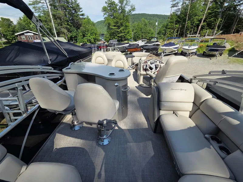 Slide: The Image of Luxurious 2018 South Bay 523 pontoon boat with plush seating and modern helm, surrounded by nature. - 15