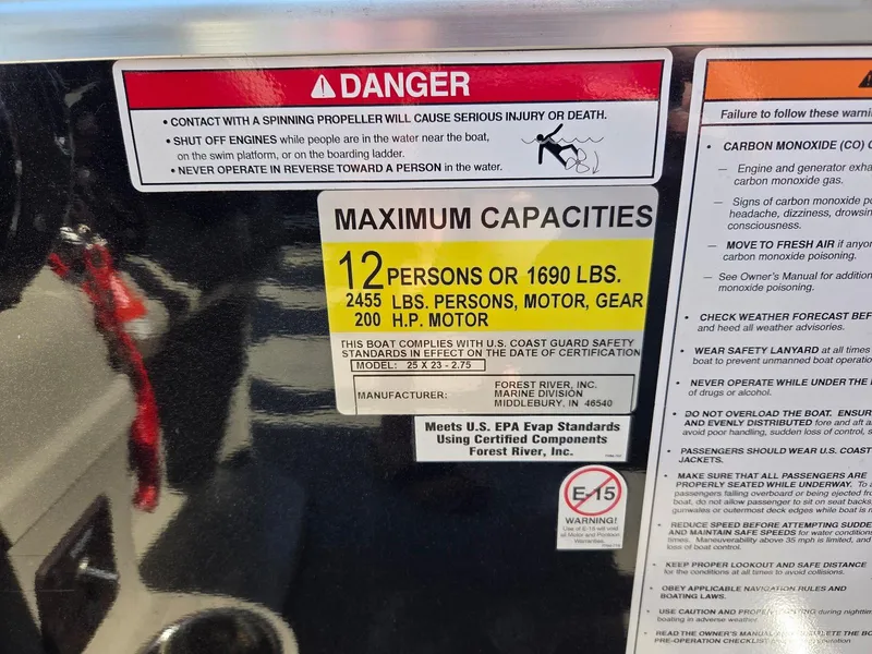Slide: The Image of Warning label on South Bay 523 boat, 2018 model, showing maximum capacity and safety instructions. - 20