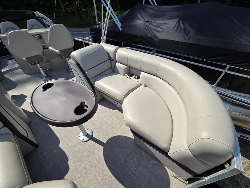 Slide: The Image of Luxurious seating on a 2018 South Bay 523 pontoon boat with a round table. - 6