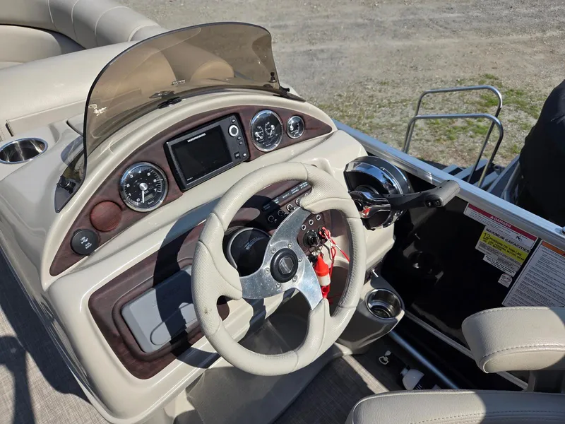 Slide: The Image of Steering console of a 2018 South Bay 523 boat with gauges and controls. - 8