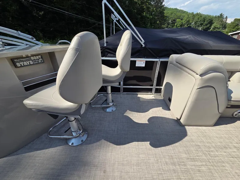 Slide: The Image of 2018 South Bay 523 boat interior with beige seating and carpeted flooring. - 9