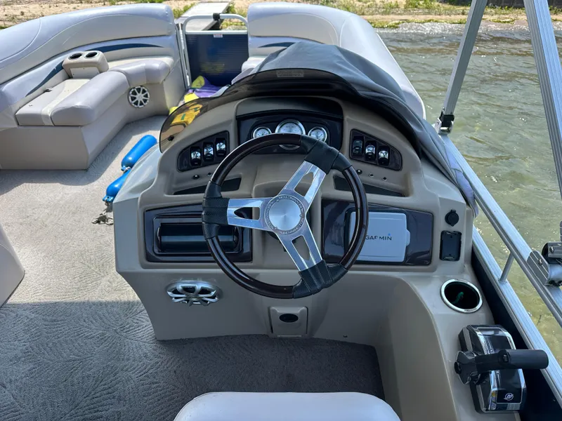 Slide: The Image of Interior view of a 2012 Bennington 2275 GS boat cockpit with steering wheel and controls. - 19