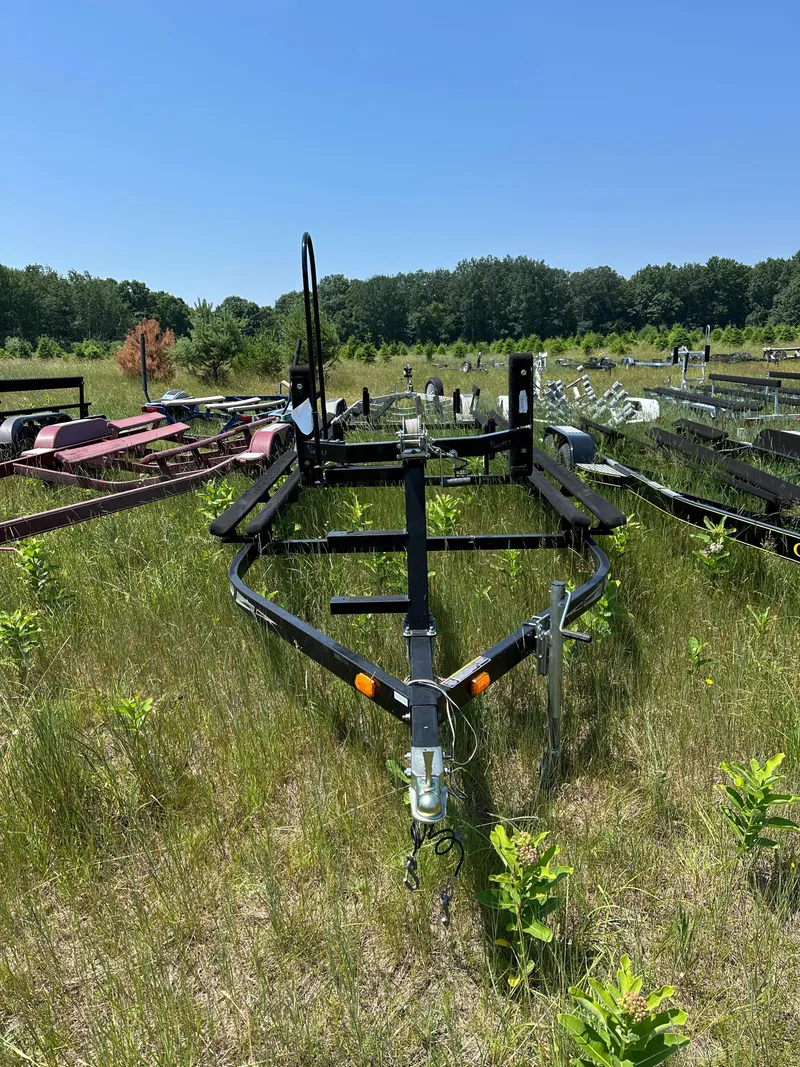 Slide: The Image of Trailer for 2012 Bennington 2275 GS in grassy field under clear blue sky. - 25