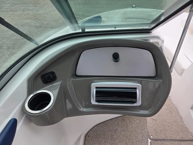 Slide: The Image of 2013 Rinker 186 Captiva boat dashboard with cup holder and storage compartment. - 10