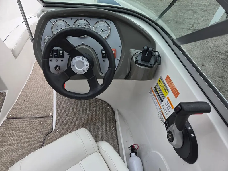 Slide: The Image of 2013 Rinker 186 Captiva boat dashboard with steering wheel and controls. - 11
