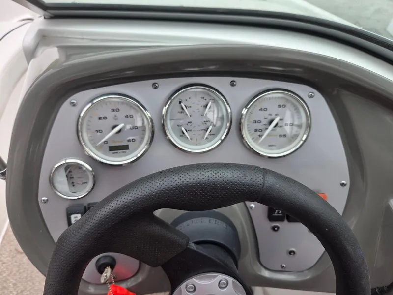 Slide: The Image of Dashboard of a 2013 Rinker 186 Captiva boat with gauges and steering wheel. - 12