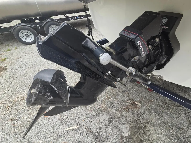 Slide: The Image of 2013 Rinker 186 Captiva boat with MerCruiser Alpha One outdrive on gravel surface. - 13