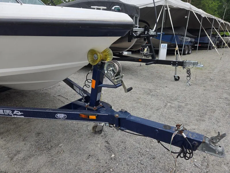 Slide: The Image of 2013 Rinker 186 Captiva boat on trailer, parked outdoors under a canopy. - 4