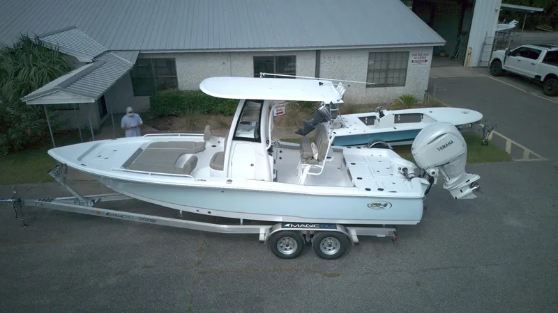The Image of 2026 Sea Hunt BX 25 FS boat on trailer, parked outside a building. - 1