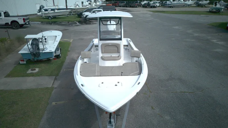 Slide: The Image of 2026 Sea Hunt BX 25 FS boat on trailer in marina parking area. - 2