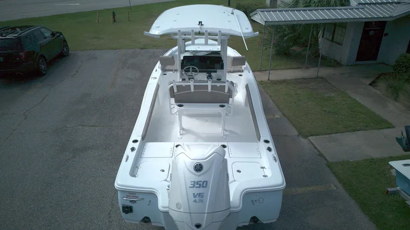 Slide: The Image of 2026 Sea Hunt BX 25 FS boat with Yamaha 350 V6 engine, parked on pavement. - 3