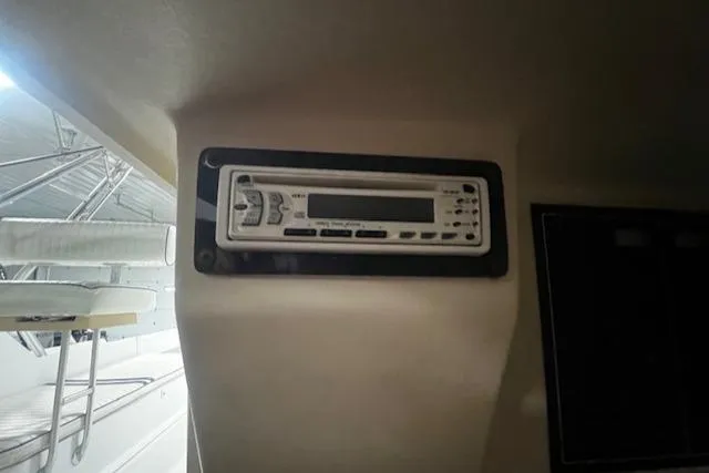 Slide: The Image of 1999 Mainship Pilot 30 Softtop Cruiser interior with mounted stereo system. - 12