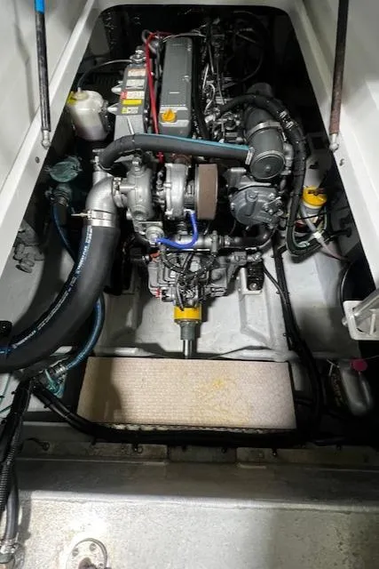 Slide: The Image of Engine compartment of a 1999 Mainship Pilot 30 Softtop Cruiser, showcasing detailed mechanical components. - 14