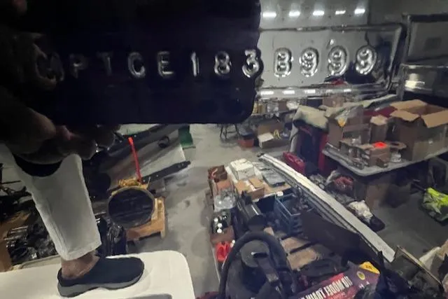 Slide: The Image of 1999 Mainship Pilot 30 Softtop Cruiser hull identification number in a workshop setting. - 15