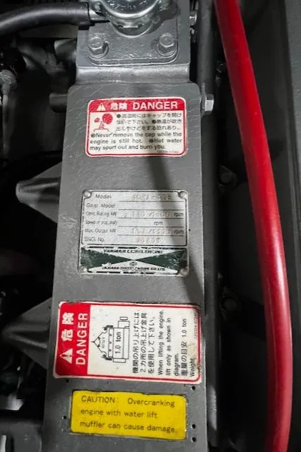Slide: The Image of Engine warning labels on a 1999 Mainship Pilot 30 Softtop Cruiser. - 16