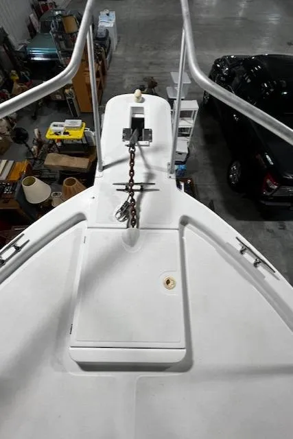 Slide: The Image of 1999 Mainship Pilot 30 Softtop Cruiser bow with anchor chain in a storage facility. - 17