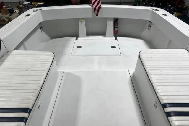 Slide: The Image of 1999 Mainship Pilot 30 Softtop Cruiser interior with striped seating and American flag. - 18