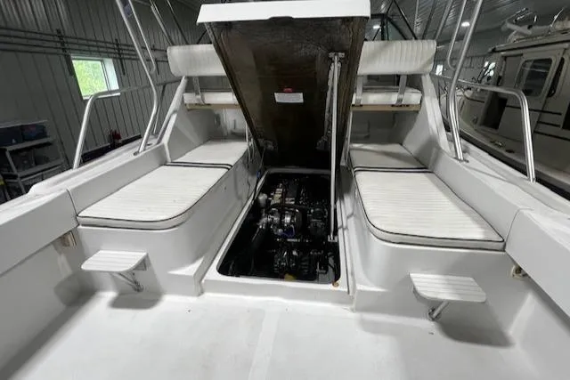 Slide: The Image of 1999 Mainship Pilot 30 Softtop Cruiser engine compartment with open hatch, showcasing interior details. - 7