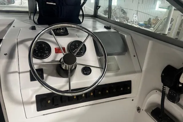 Slide: The Image of 1999 Mainship Pilot 30 Softtop Cruiser helm with steering wheel and instrument panel. - 8