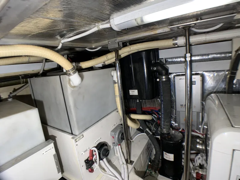 Slide: The Image of Engine room of a 2006 Carver 56 Voyager yacht with various mechanical components. - 38