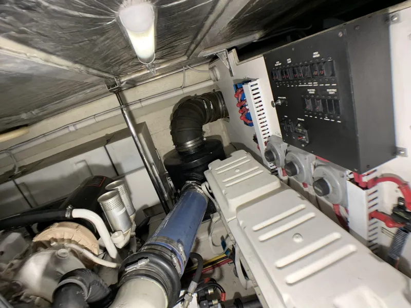 Slide: The Image of Engine room of a 2006 Carver 56 Voyager yacht with visible components and control panel. - 45