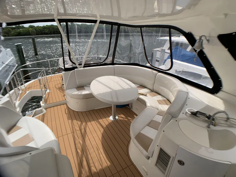 Slide: The Image of 2006 Carver 56 Voyager yacht with spacious deck and seating area. - 10