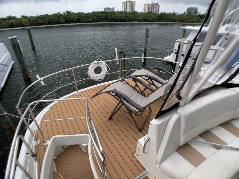 Slide: The Image of 2006 Carver 56 Voyager yacht deck with lounge chairs and waterfront view. - 12
