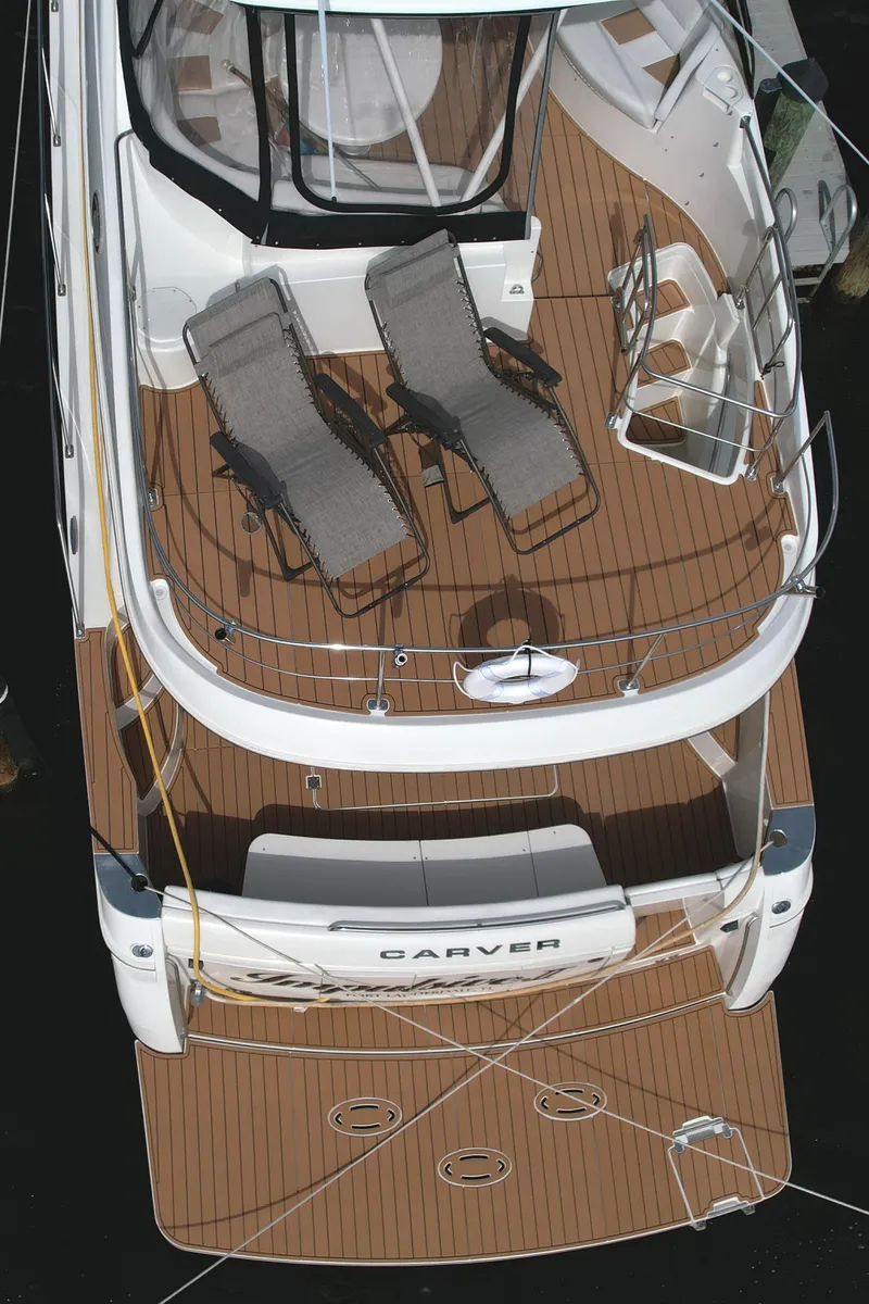 Slide: The Image of 2006 Carver 56 Voyager yacht with spacious deck and lounge chairs. - 17
