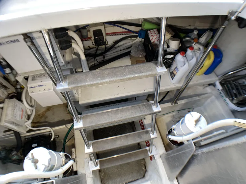 Slide: The Image of Engine room of a 2006 Carver 56 Voyager yacht with metal steps and equipment. - 26