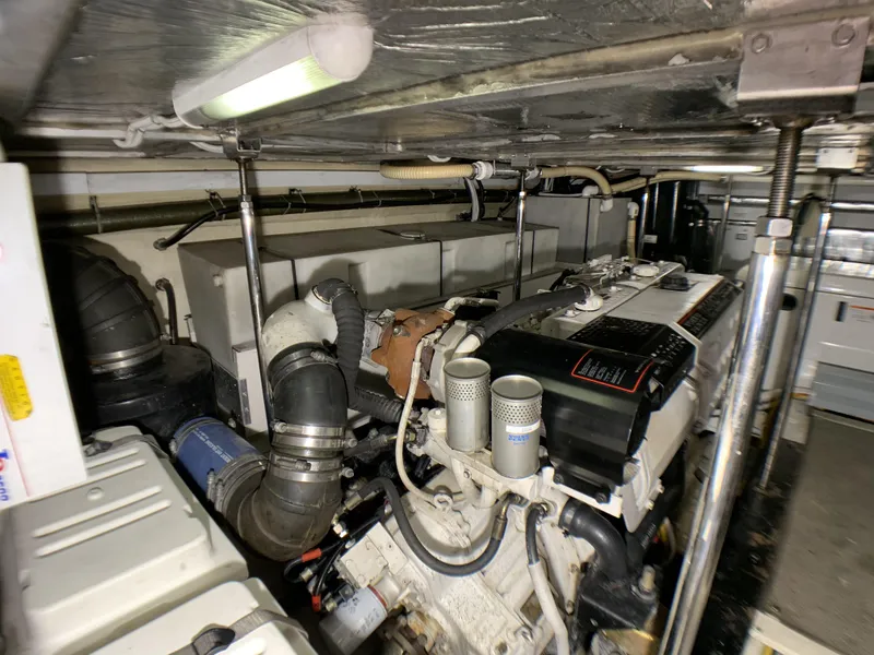 Slide: The Image of Engine room of a 2006 Carver 56 Voyager yacht with visible machinery. - 30
