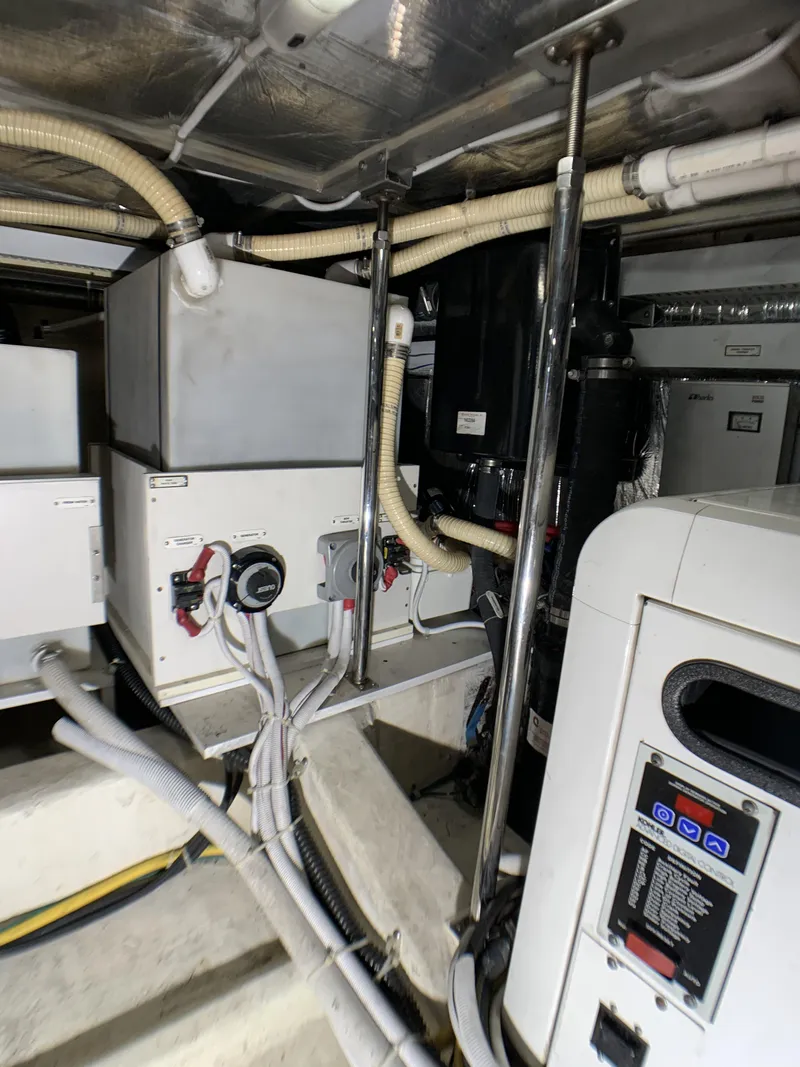 Slide: The Image of Engine room of a 2006 Carver 56 Voyager yacht with various mechanical components. - 36