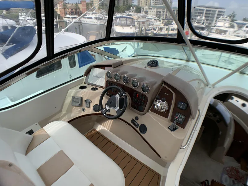 Slide: The Image of 2006 Carver 56 Voyager yacht helm with modern controls and panoramic marina view. - 4