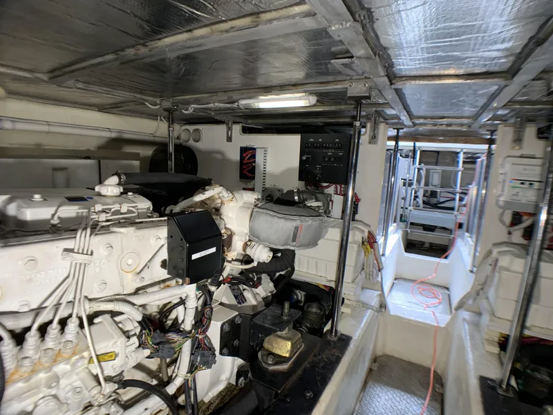 Slide: The Image of Engine room of a 2006 Carver 56 Voyager yacht with visible machinery and equipment. - 43