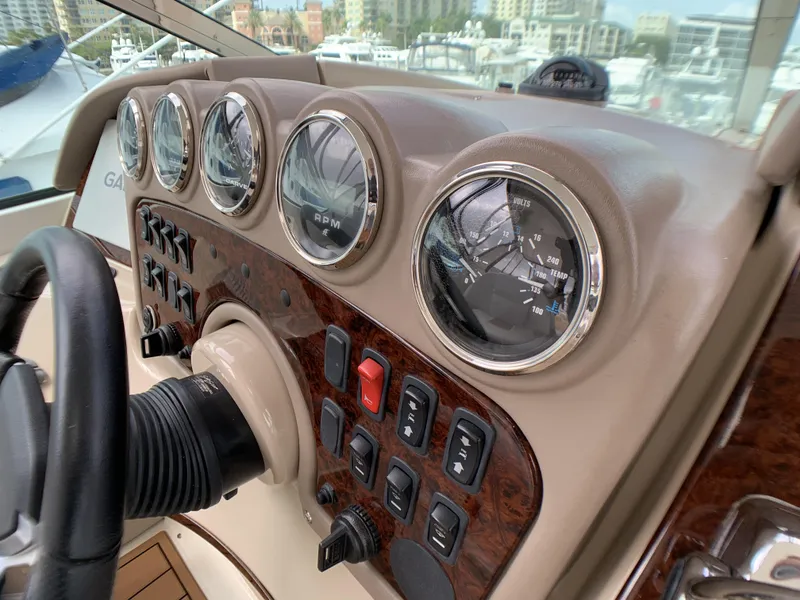 Slide: The Image of 2006 Carver 56 Voyager dashboard with gauges and controls in a marina. - 6