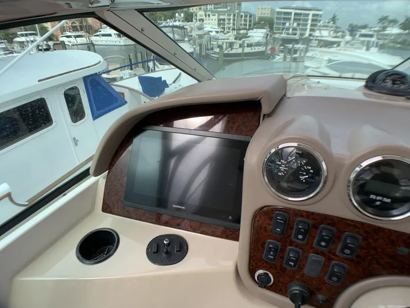 Slide: The Image of Control panel of a 2006 Carver 56 Voyager yacht with a marina view. - 7