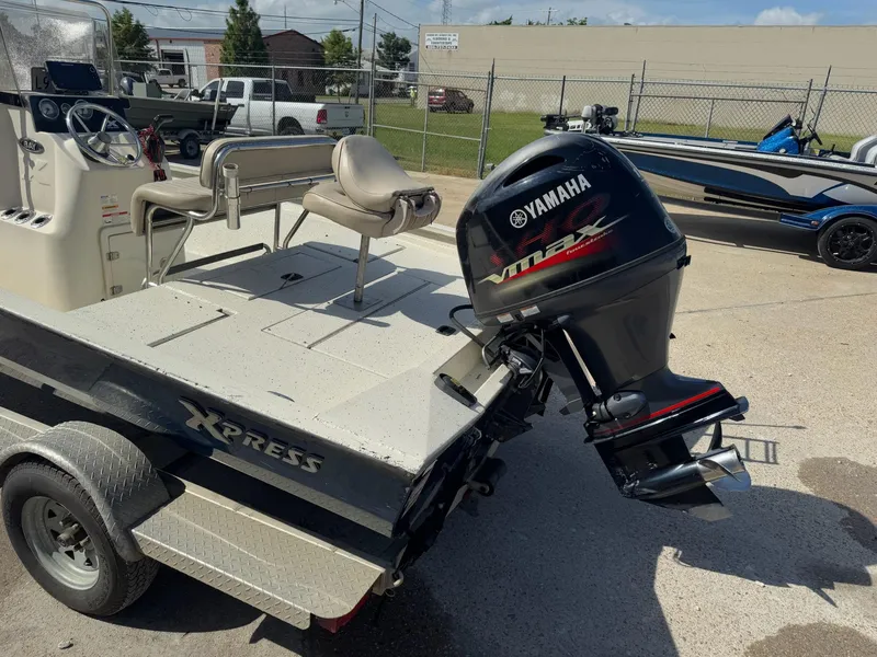 Slide: The Image of 2017 Xpress H20B boat with Yamaha outboard motor, parked on a trailer. - 10