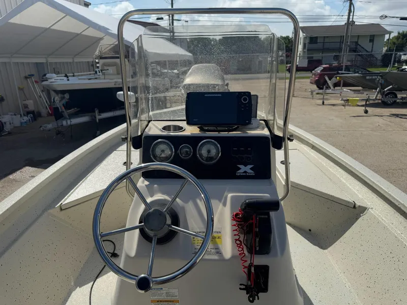Slide: The Image of 2017 Xpress H20B boat console with steering wheel and navigation equipment. - 15