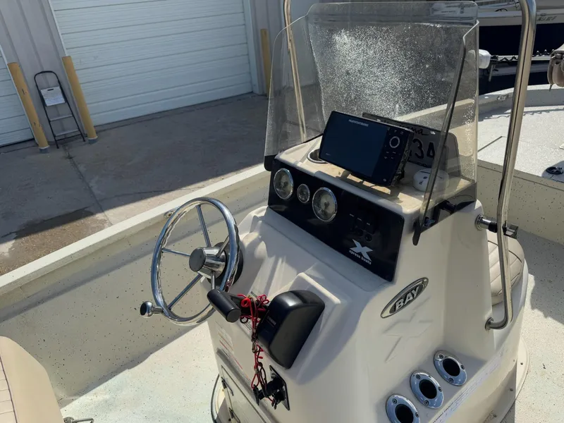 Slide: The Image of 2017 Xpress H20B boat console with steering wheel and navigation system. - 18