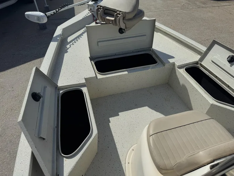 Slide: The Image of 2017 Xpress H20B boat interior with open storage compartments and seating. - 19