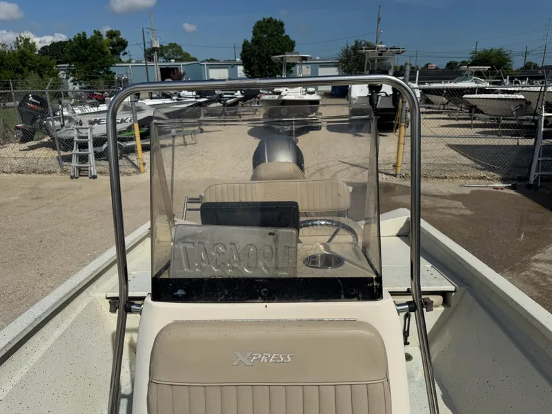 Slide: The Image of 2017 Xpress H20B boat in a marina, surrounded by other boats and clear skies. - 21