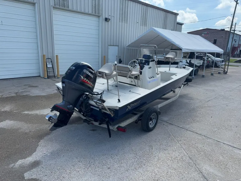 Slide: The Image of 2017 Xpress H20B boat with Yamaha motor parked outside a warehouse. - 7
