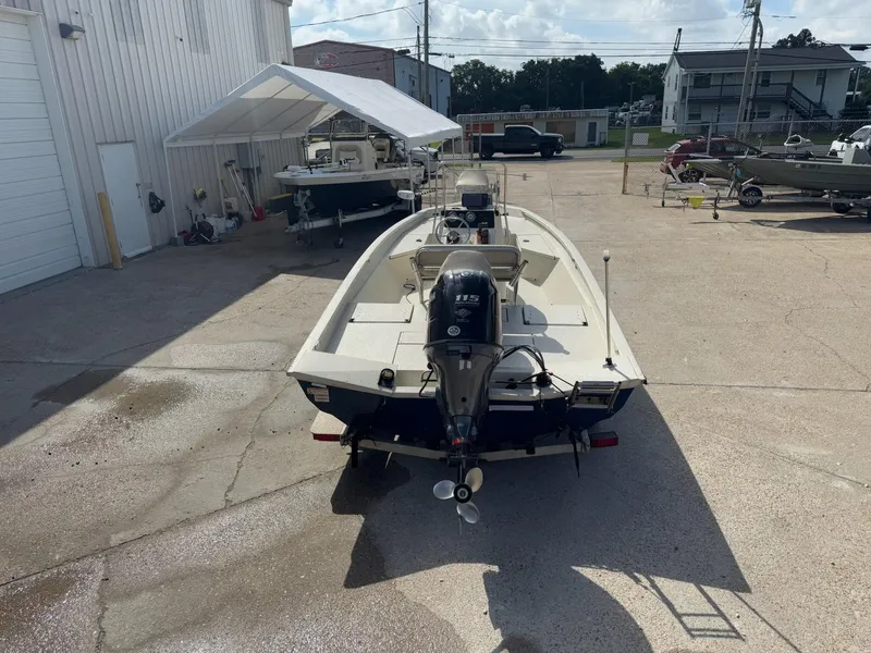 Slide: The Image of 2017 Xpress H20B boat with outboard motor in a parking lot. - 8