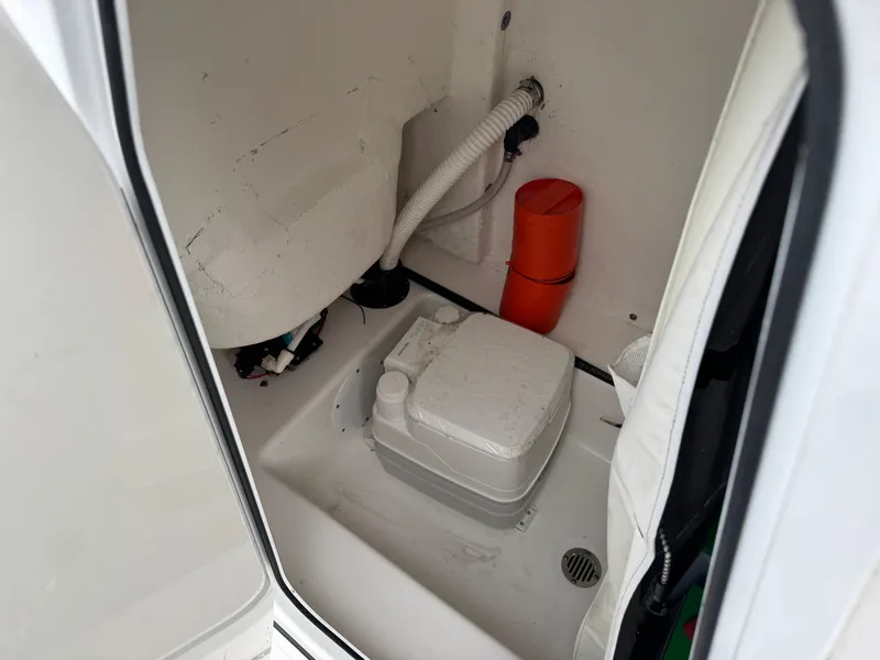 Slide: The Image of Interior of 2017 Tidewater 230 CC Adventure boat with portable toilet and storage. - 11