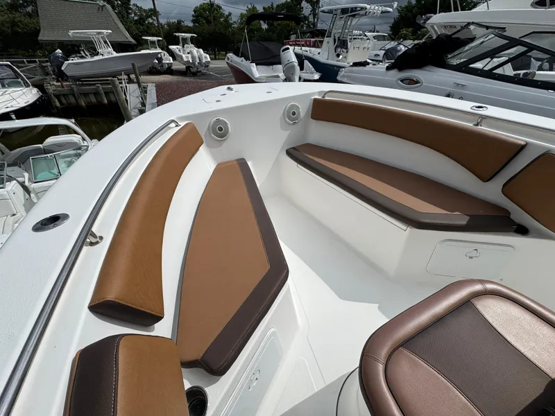 Slide: The Image of 2017 Tidewater 230 CC Adventure boat interior with brown cushioned seating. - 15