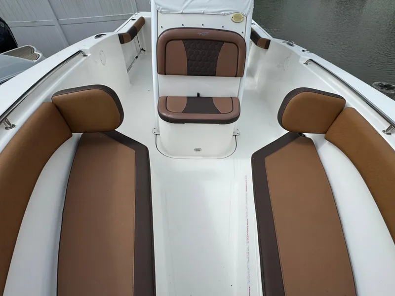 Slide: The Image of 2017 Tidewater 230 CC Adventure boat interior with brown cushioned seating. - 17