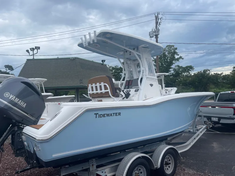 Slide: The Image of 2017 Tidewater 230 CC Adventure boat on trailer, featuring Yamaha engine, under cloudy sky. - 21