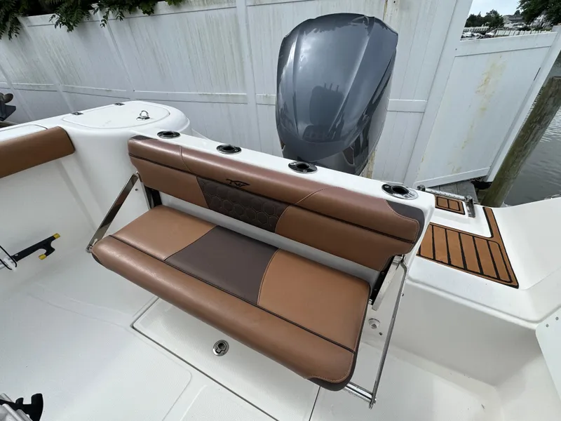 Slide: The Image of 2017 Tidewater 230 CC Adventure boat with brown seating and outboard motor. - 3