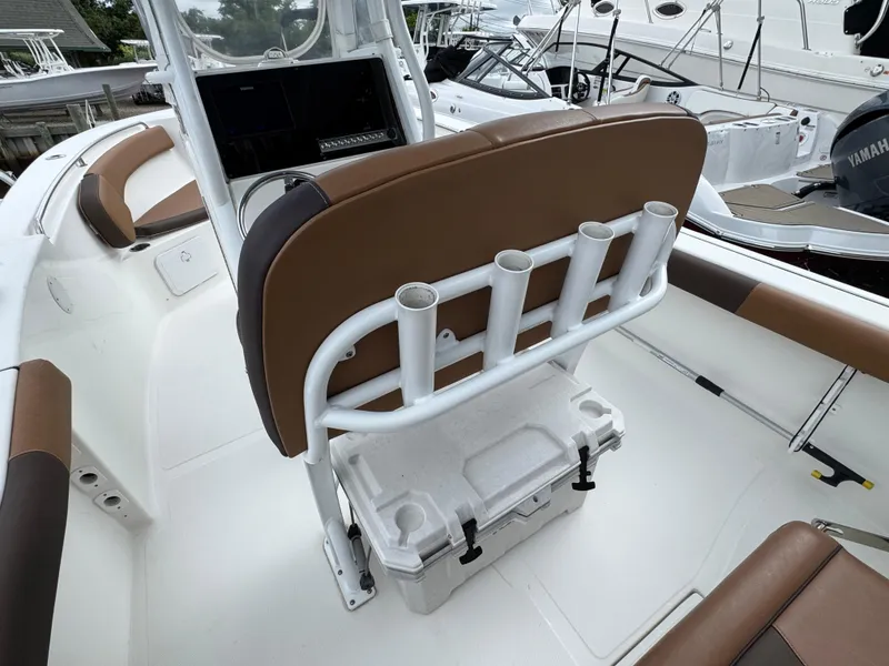 Slide: The Image of 2017 Tidewater 230 CC Adventure boat interior with brown seating and rod holders. - 4